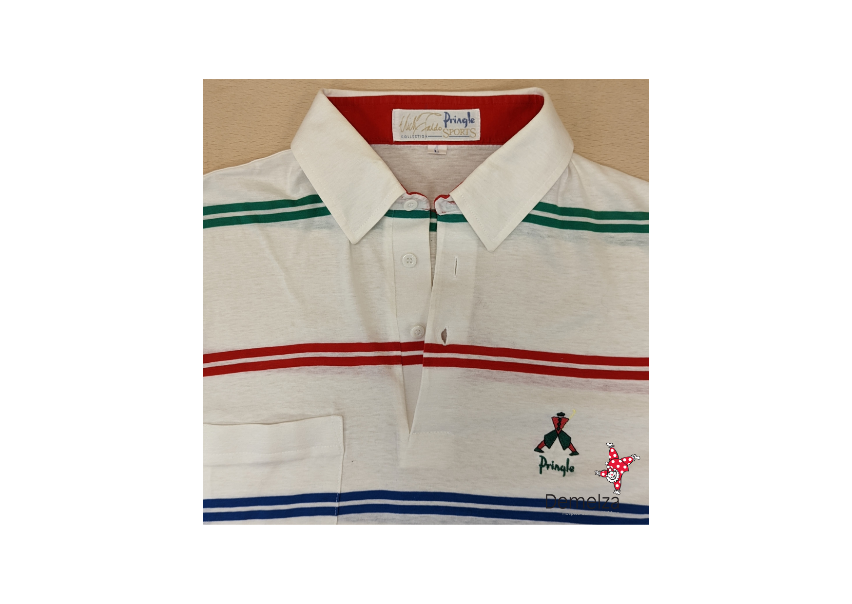 White polo with thin green, blue and yellow Lines. Retro design embroidery to chest