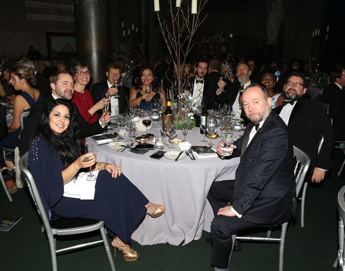 Guests sitting at their table at the winter wonderland ball.