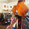 An orange scarf apart of a scarf display in Rochester's Demelza charity shop