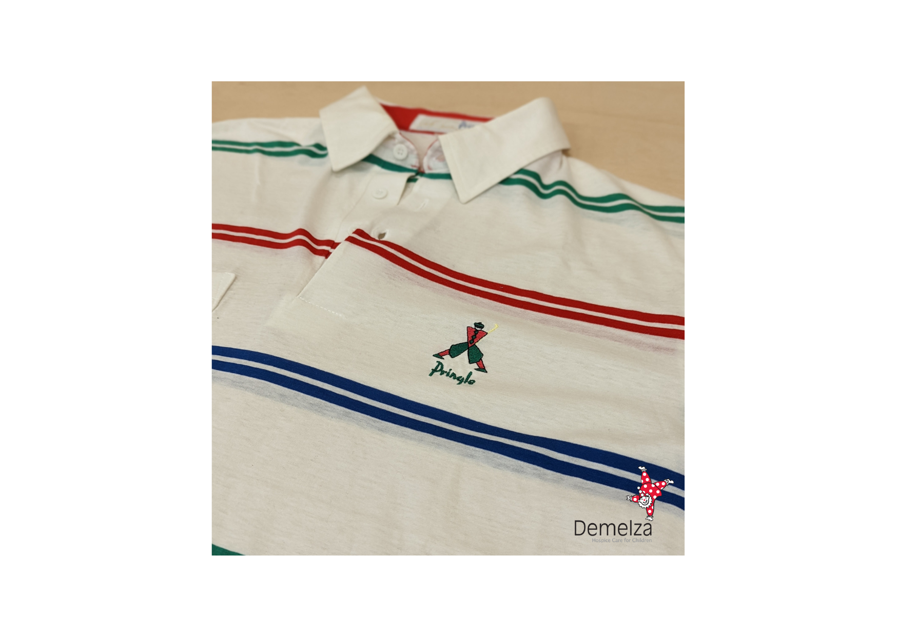 White polo with thin green, blue and yellow Lines. Retro design embroidery to chest