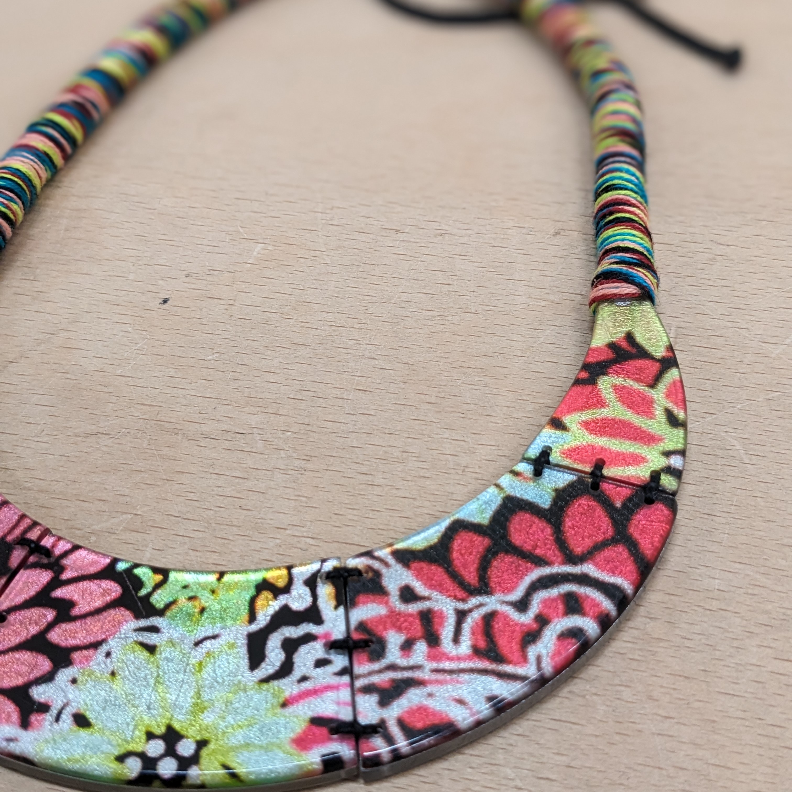 Close up picture of Culture Vulture statement necklace multicoloured floral rope design