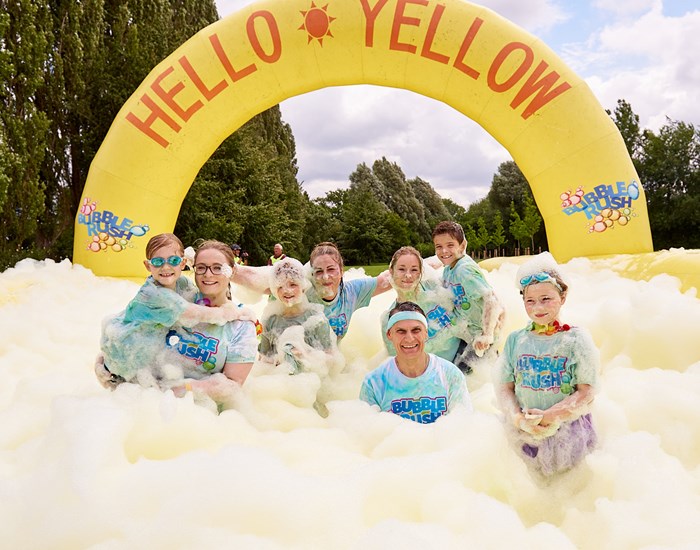 Bubble Rush participants surrounded by yellow bubbles.