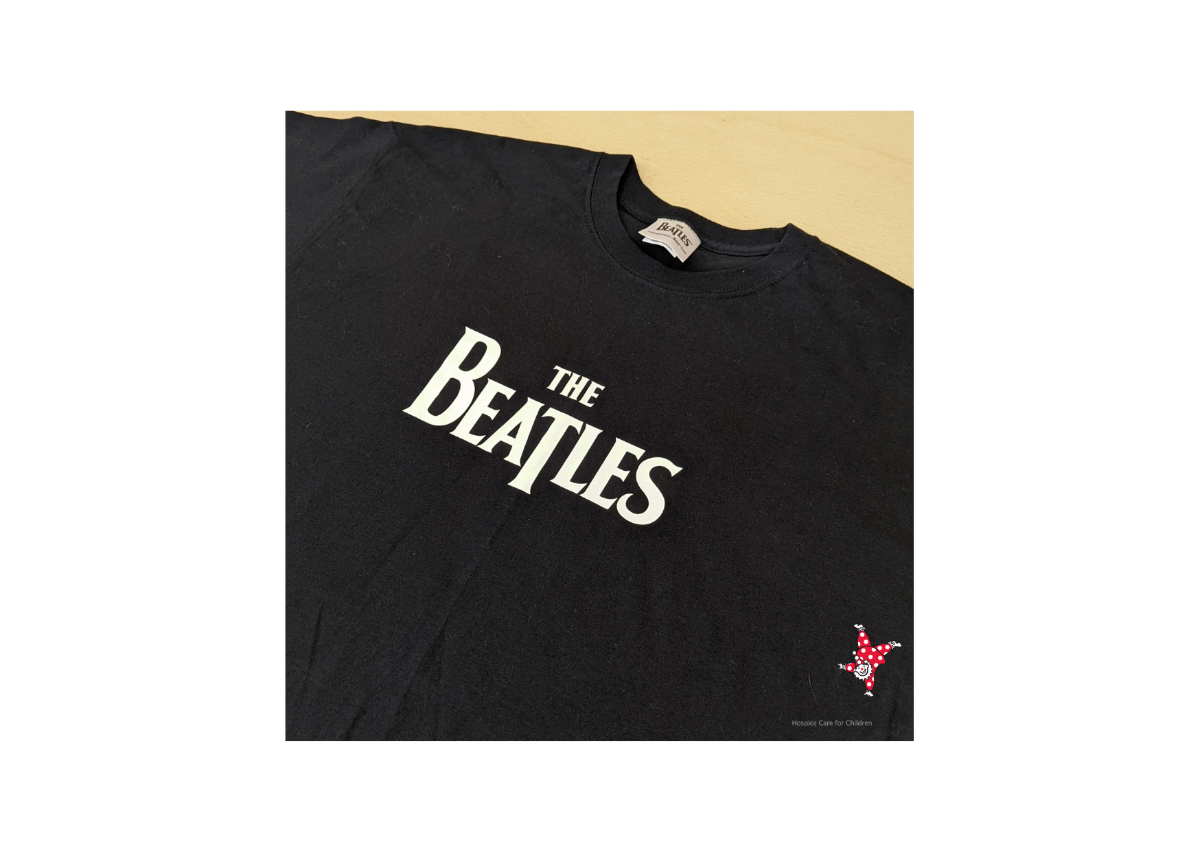 Plain black t shirt with "The Beatles" in white spell out