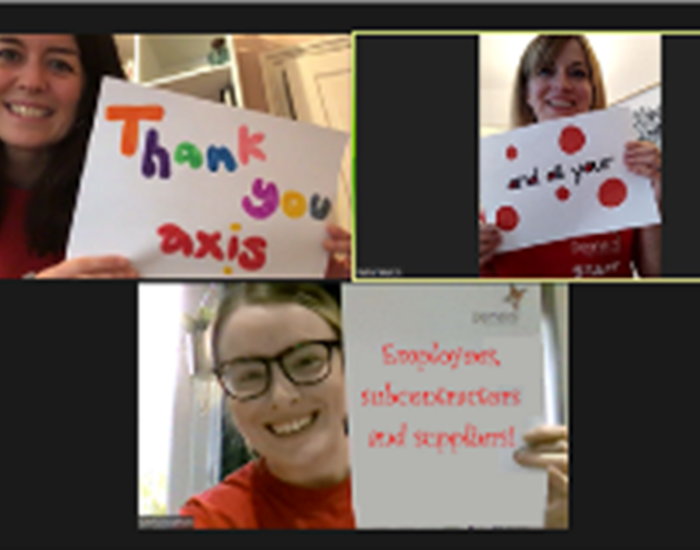 Demelza corporate team hold up thank you signs whilst on Zoom.
