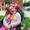 Fia sitting happily at East Sussex Family Fest 2025, dressed in a brightly coloured outfit with matching accessories