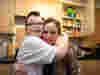 Son and mom hugging in kitchen