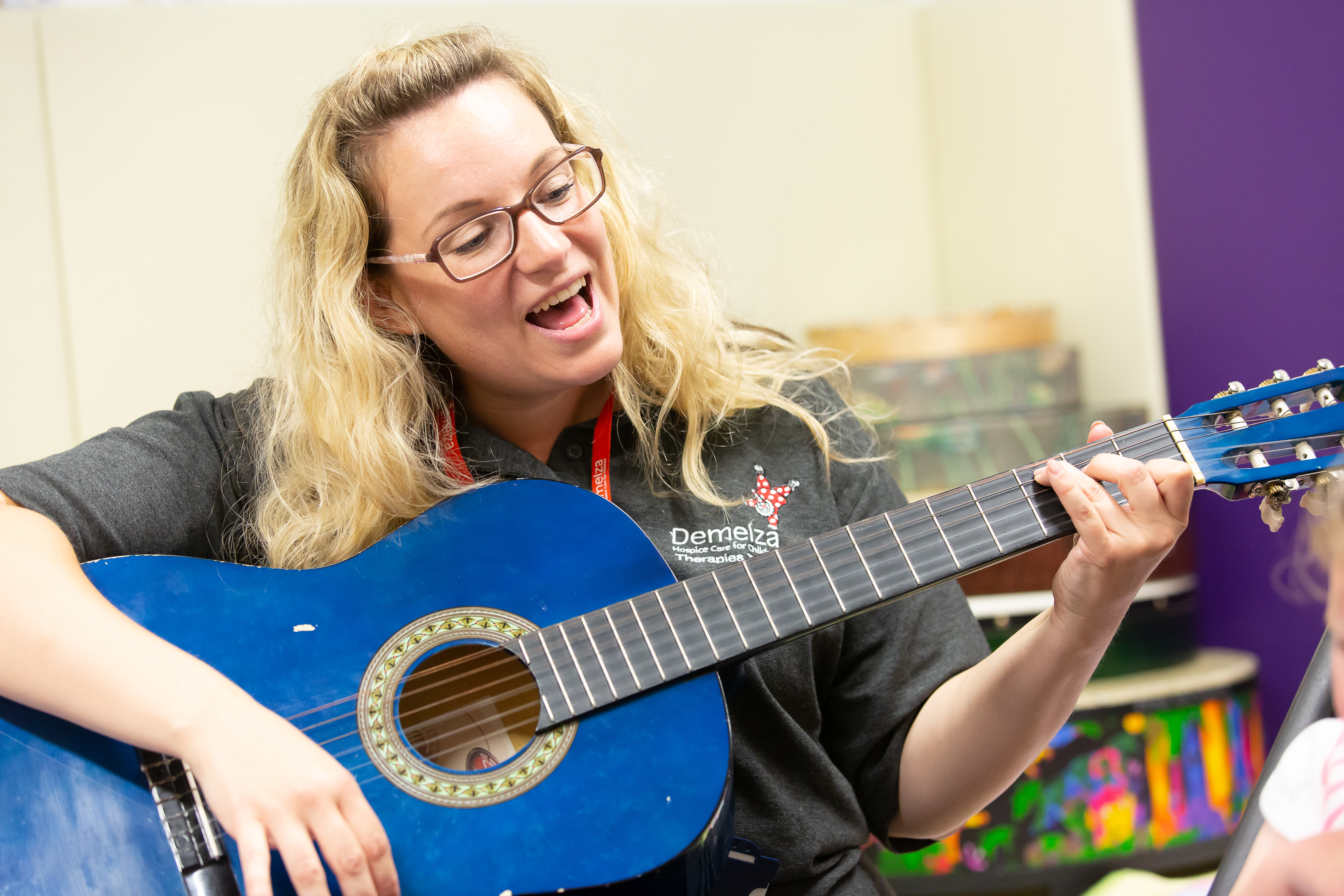 Music therapist, Victoria, singing and playing guitar