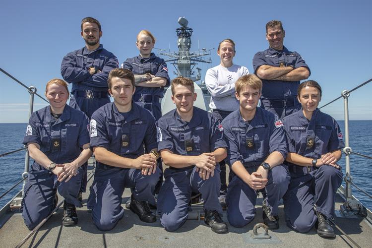 Group photo of HMS Kent sailors, wearing navy uniforms.
