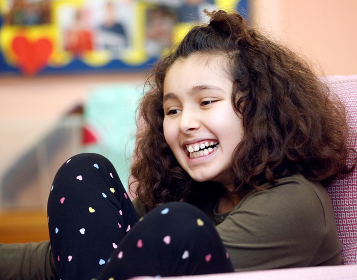 A girl enjoys the cinema room at Demelza's Kent hospice.