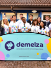Corporate team with Demelza branded sign