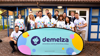 Corporate team with Demelza branded sign