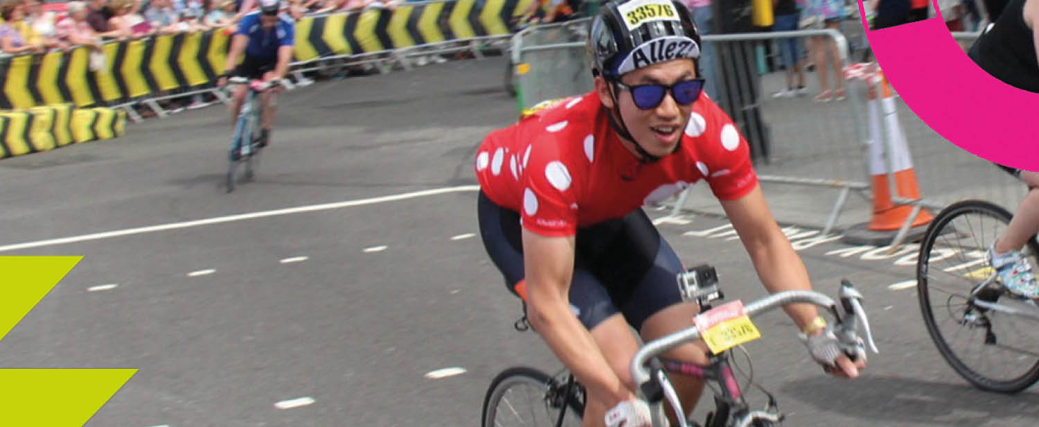 A Ride London cyclist, wearing a Demelza polka dot cycling top.