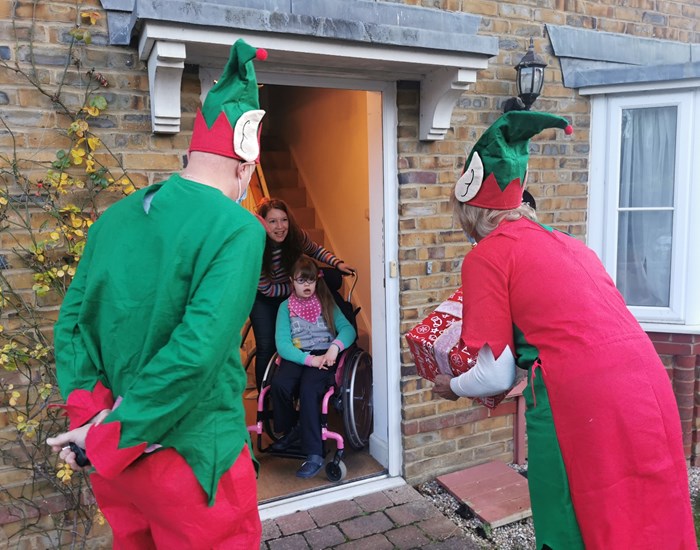 Lucy receiving a present from the Demelza Elves as part of the Christmas Appeal