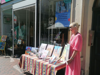 Artist with works of art outside Demelza shop