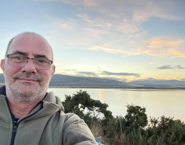 Fundraiser Paul Green, takes a 'selfie' in front of a beautiful blue and pink sky.