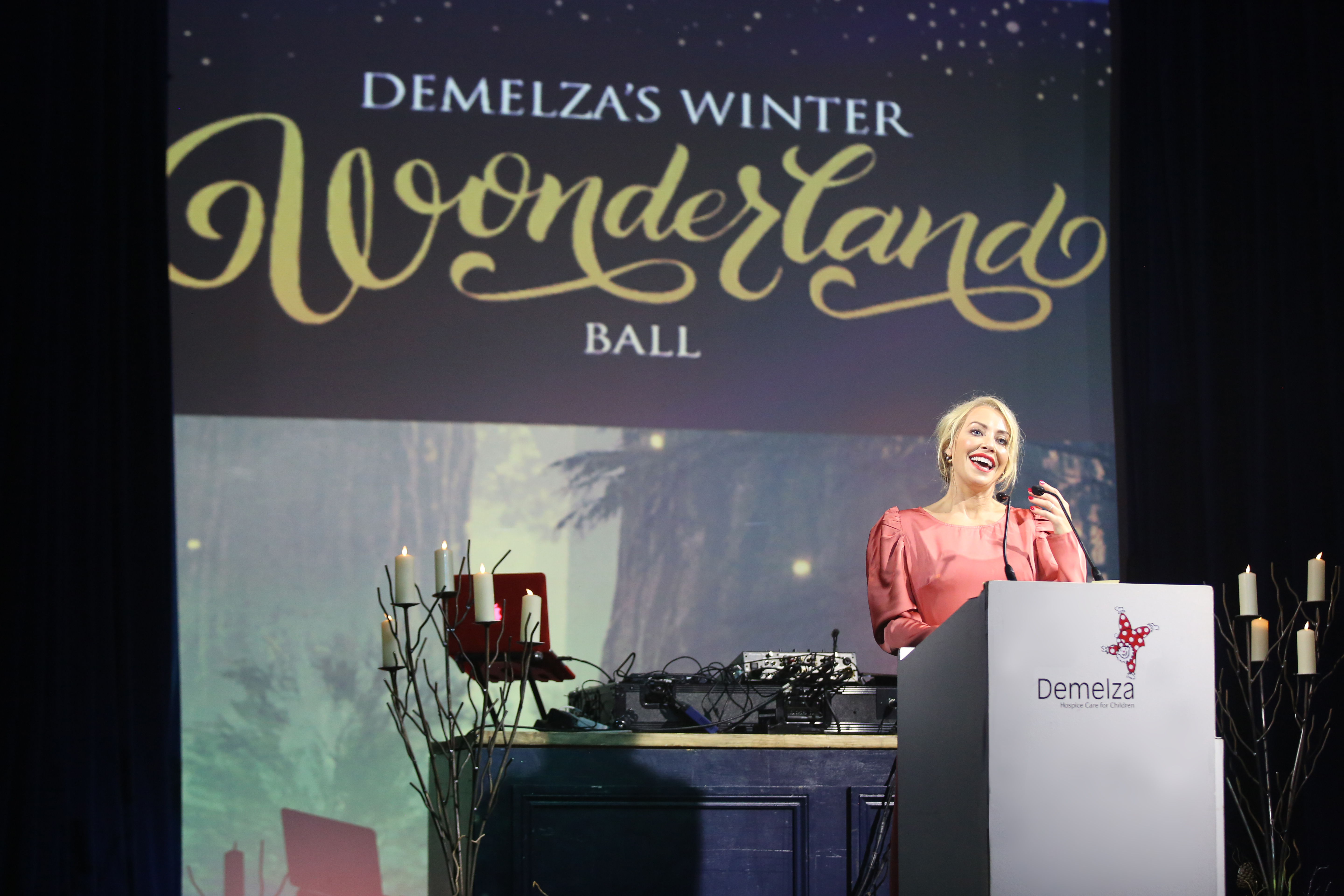 Celebrity host, Laura, speaking at the winter wonderland ball.