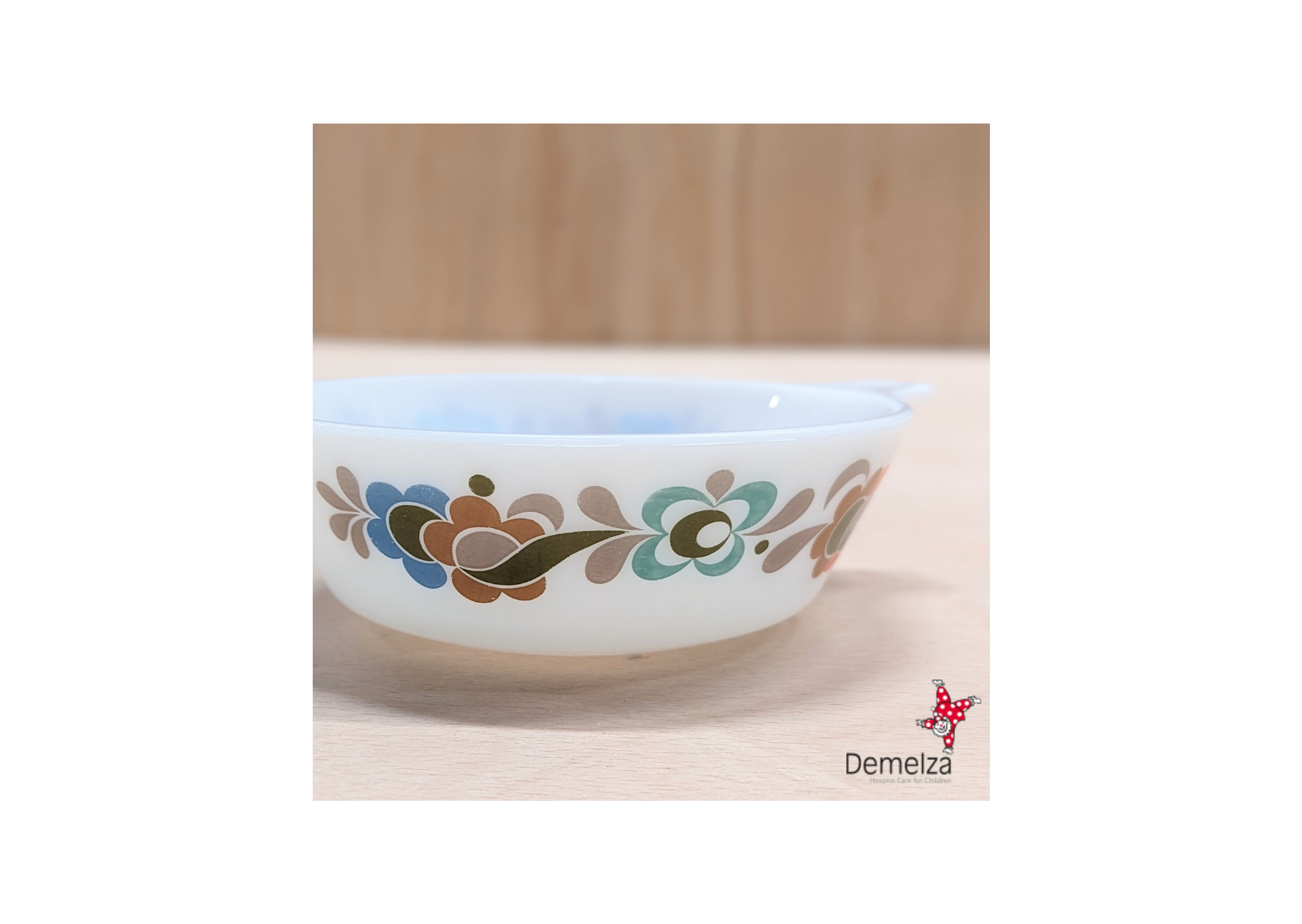 White dish with abstract floral pattern in brown, orange, blue & green