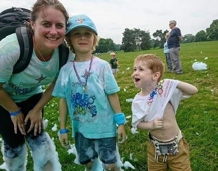 Zak with his mum and brother at Bubble Rush.