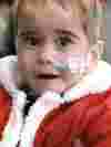 Child in santa costume looking at camera