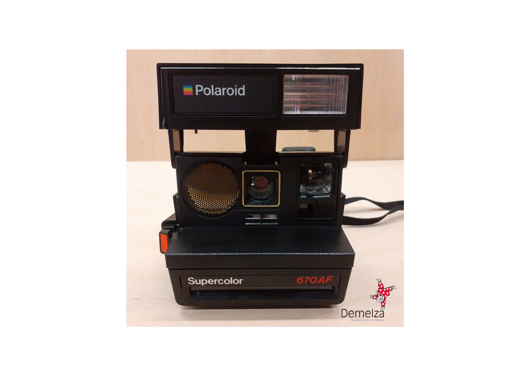 Front of Vintage Polaroid Supercolor 670 AF Instant Camera in Black with Flash Open