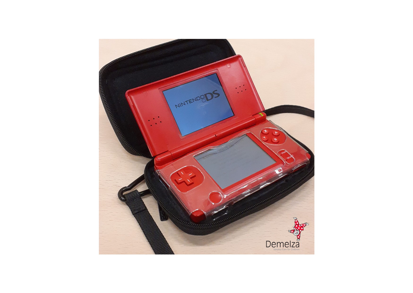 Red Nintendo DS Lite with black zip up carry case