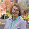 Vice Chair Paula Wilkins smiles outdoors, wearing a blue stripy blouse and glasses.