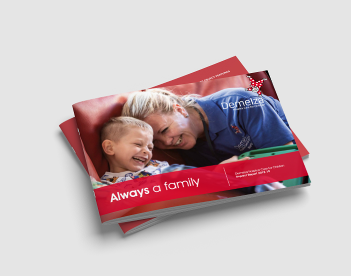 The front cover of the Impact Report, showing a Demelza nurse laughing with a child.