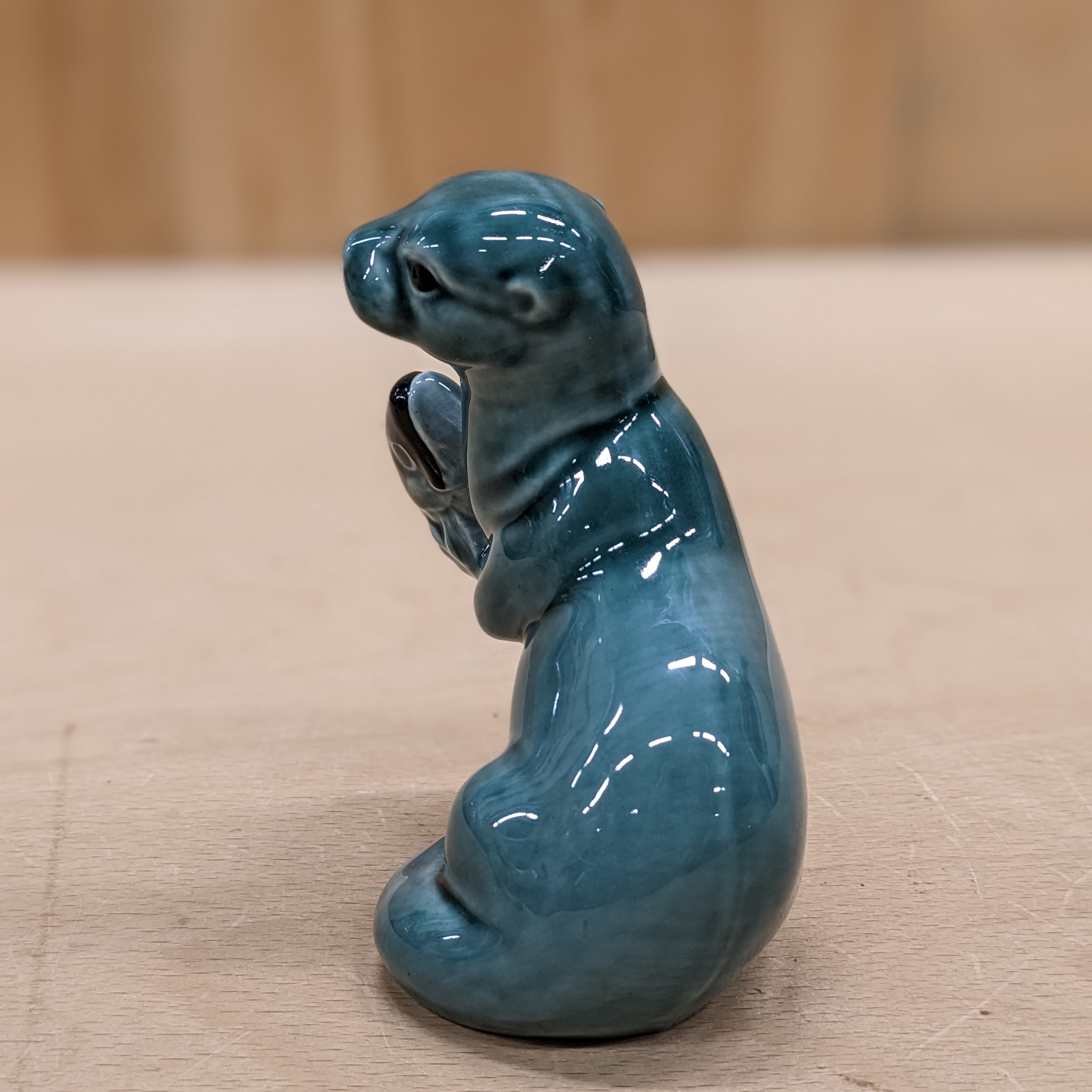 Side view of Vintage Poole Pottery Otter Blue with Fish Figurine Ornament