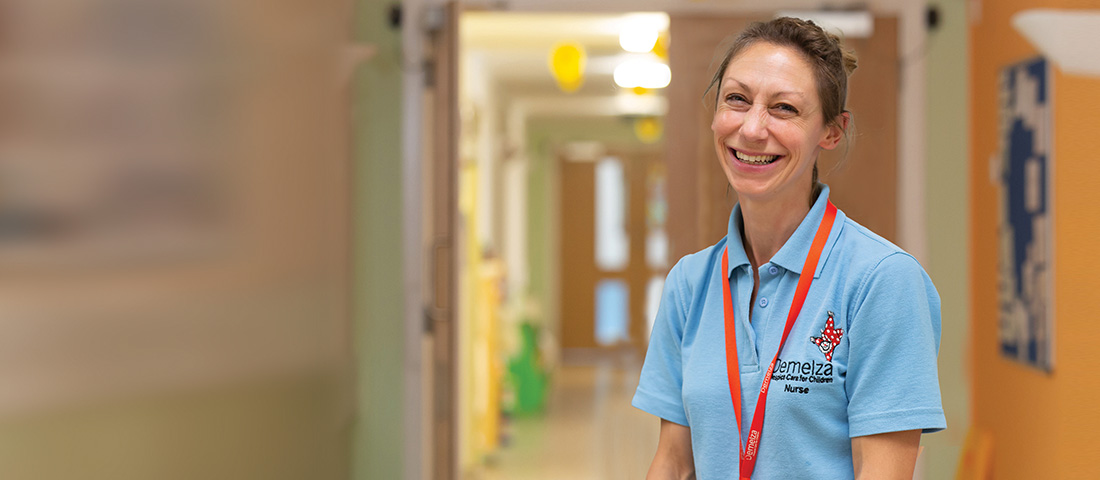 A registered nurse standing in the Care corridor.