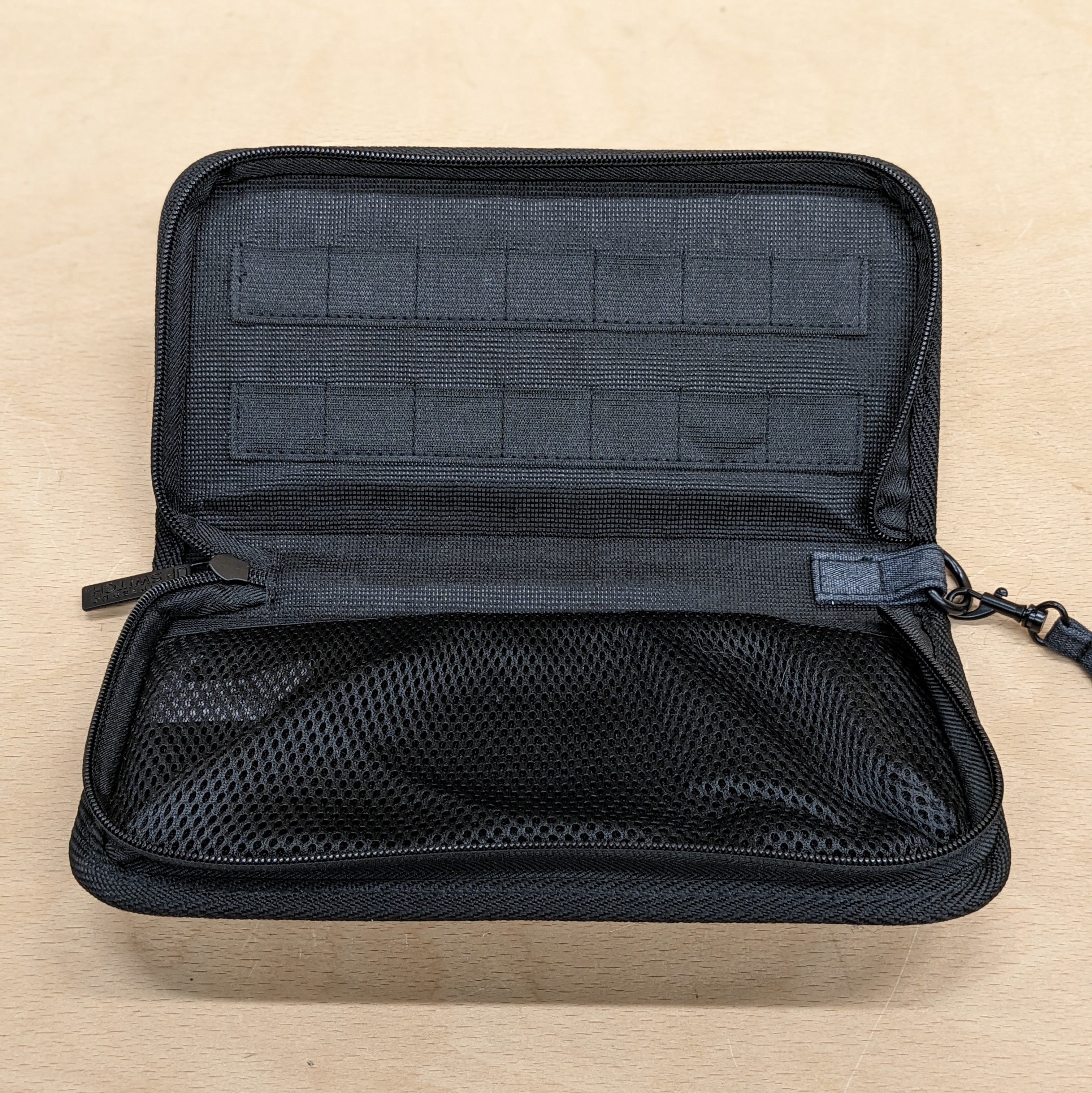 Nintendo switch official grey carry case inside slots of cartridges and console pouch