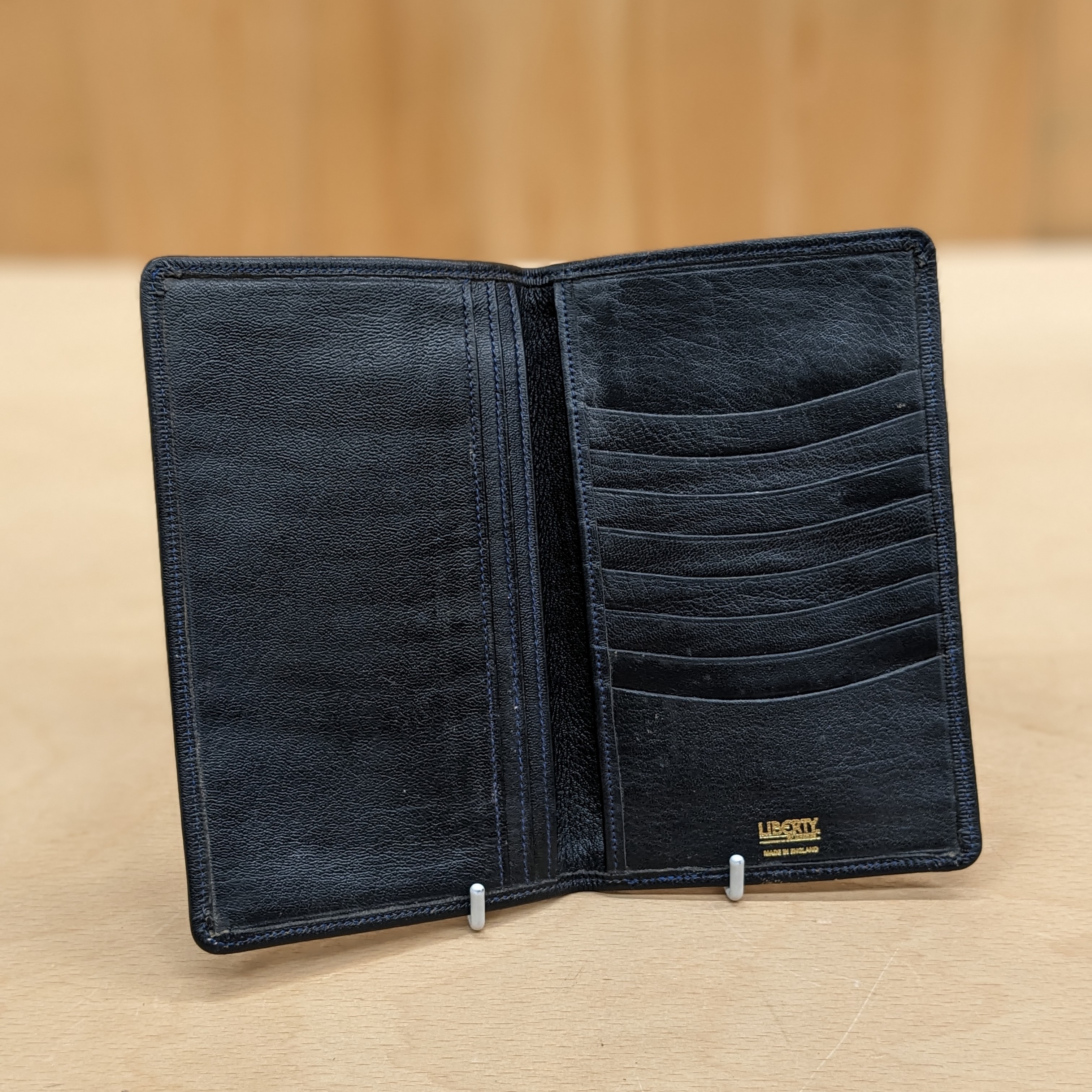 Liberty of London card holder opened showing Leather card slots and larger pockets