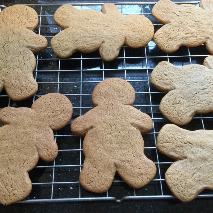 Baked gingerbread men, on a cooling tray.