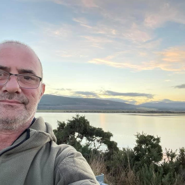 Fundraiser Paul Green, takes a 'selfie' in front of a beautiful blue and pink sky.