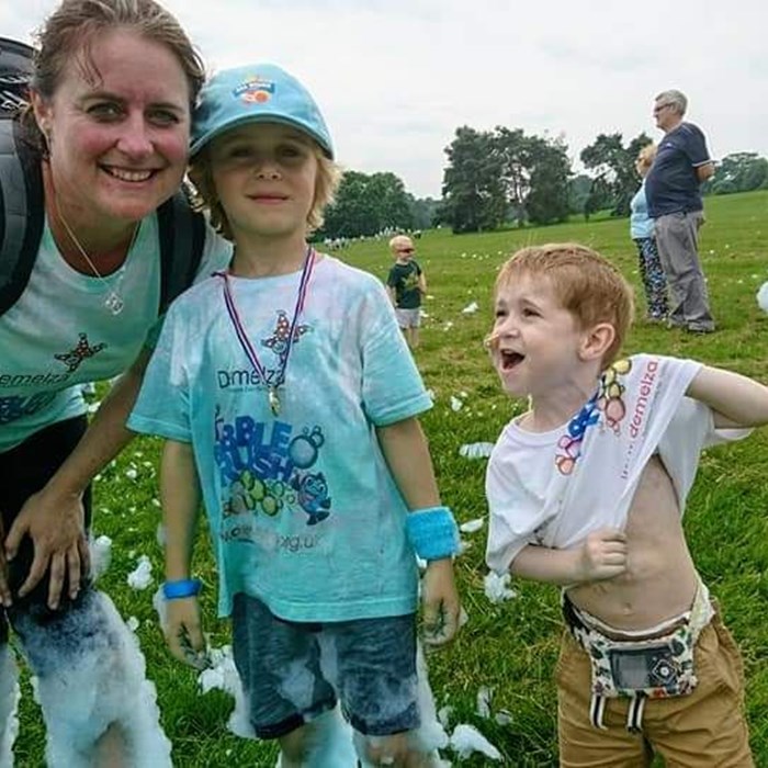 Zak with his mum and brother at Bubble Rush.